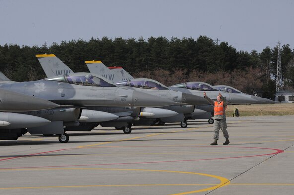 An Airman assigned to the 35th Fighter Wing marshals an F-16 Fighting Falcon for an end-of-runway inspection at Misawa Air Base, Japan during an operational readiness exercise April 28, 2012. EOR inspections are performed to ensure munitions are properly attached to aircraft and ensure they are secure prior to taking off. Although the wing simulated launching several fighters, the purpose of the exercise is to demonstrate the wing’s ability to quickly generate war-ready aircraft. (U.S. Air Force photo/Airman Kenna Jackson)