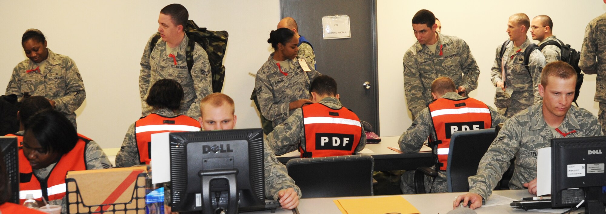 U.S. Air Force Airmen process through the personnel deployment function line during an operational readiness exercise at Misawa Air Base, Japan, April 28, 2012. The purpose of the exercise is to test the 35th Fighter Wing’s ability to deploy personnel, equipment and support assets to a combat environment. (U.S. Air Force photo by Airman Kenna Jackson/Released)