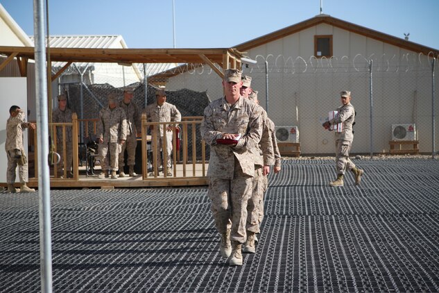 Sergeant Bryce W. Cherryholmsnoll, a native of Huxley, Iowa, serving with Task Force Leatherneck, 1st Marine Division (Forward), leads a detail of Marines to raise the American flag over the Task Force Leatherneck compound here April 28, 2012. Marines serving here have the opportunity to fly a 3-by-5-foot American flag for a day and dedicate it to someone of their choice.