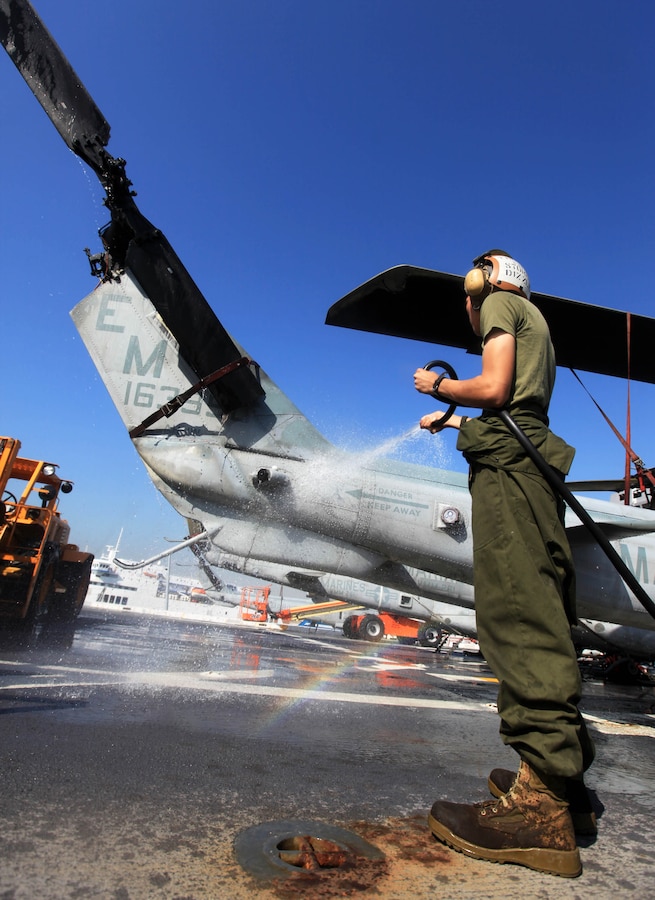 Lance Cpl. Brandon Murphy, a helicopter mechanic with Marine Medium Tiltrotor Squadron 261  (Reinforced), 24th Marine Expeditionary Unit, washes a UH-1N Huey during routine maintenance on the flight deck of the USS New York docked here, April 28, 2012. The 24th MEU is currently deployed with the Navy's Iwo Jima Amphibious Ready Group as a theater reserve and crisis response force capable of a variety of missions from full-scale combat operations to humanitarian assistance and disaster relief.