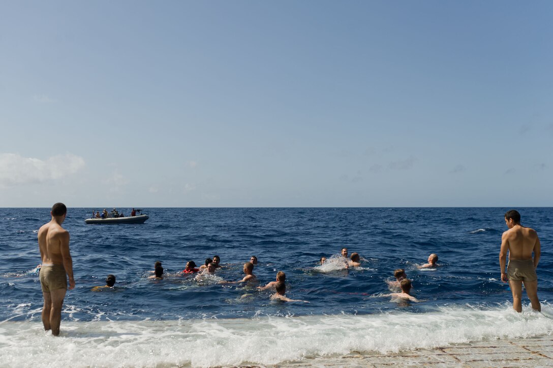 Marines with the 11th Marine Expeditionary Unit serving aboard USS Pearl Harbor swim off the ship here April 28. The unit is deployed as part of the Makin Island Amphibious Ready Group, currently a U.S. Central Command theater reserve force. The group is providing support for maritime security operations and theater security cooperation efforts in the U.S. Navy's 5th Fleet area of responsibility.