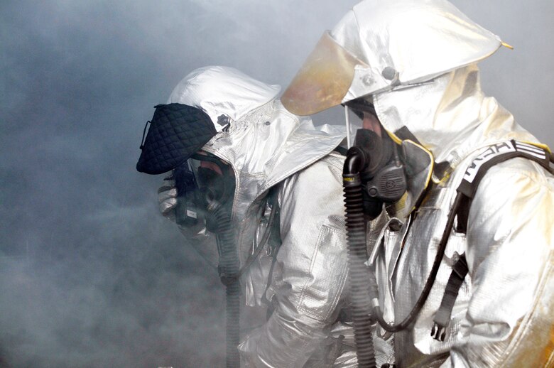 U.S. Air Force fire fighters from the 151st CES/CEF coordinate the search of a smoke filled room for an Operational Readiness Excercise April 14, 2012, at the Utah Air National Guard Base in Salt Lake City, Utah. (U.S. Air Force Photo by Tech. Sgt. Jeremy Giacoletto-Stegall/Released)