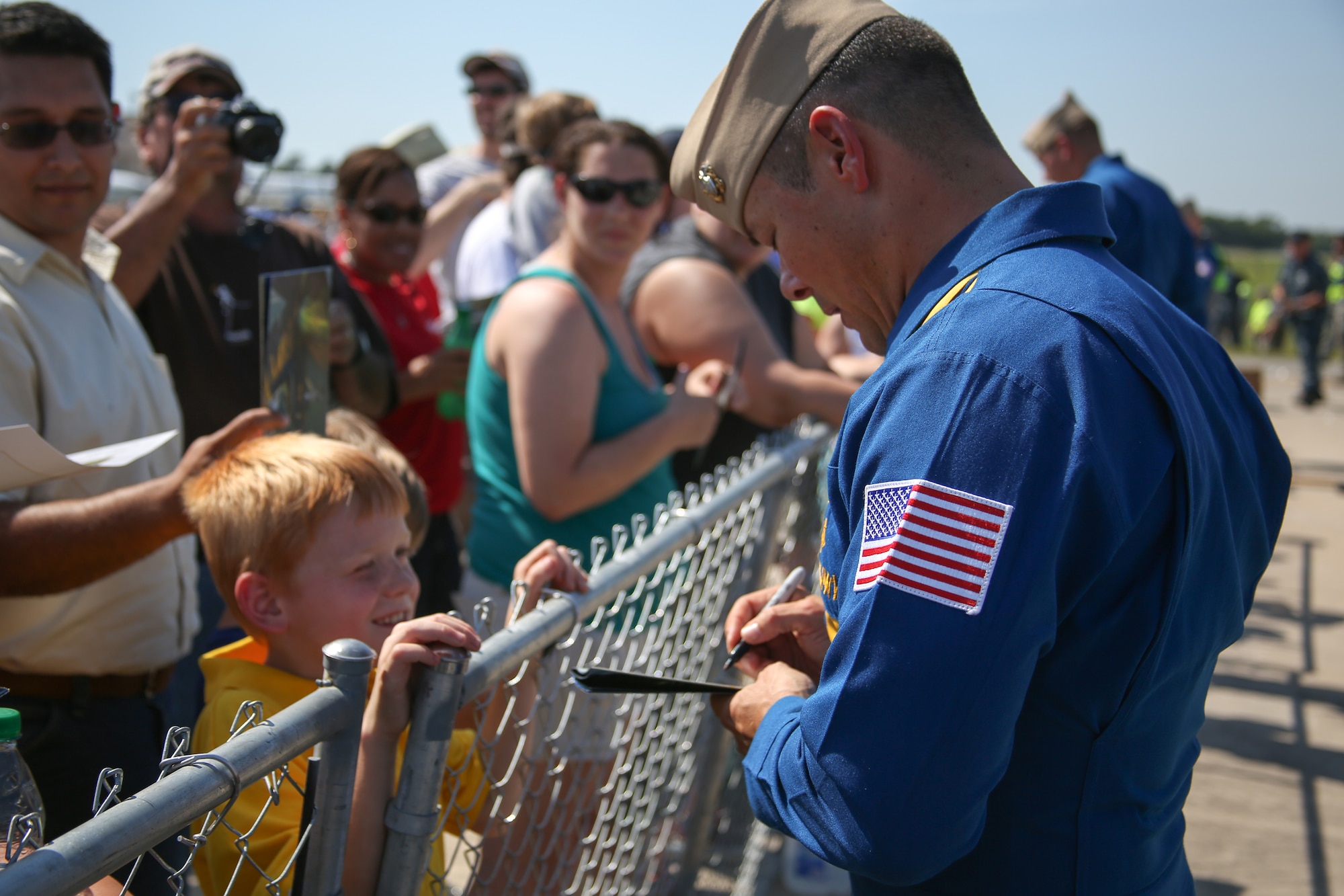 Navy Capt. Greg McWherter, commanding officer for the Blue Angels, signs autographs at the 2012 Robins Air Show. (U.S. Air Force photo by 1st Lt. Joel Cooke)
