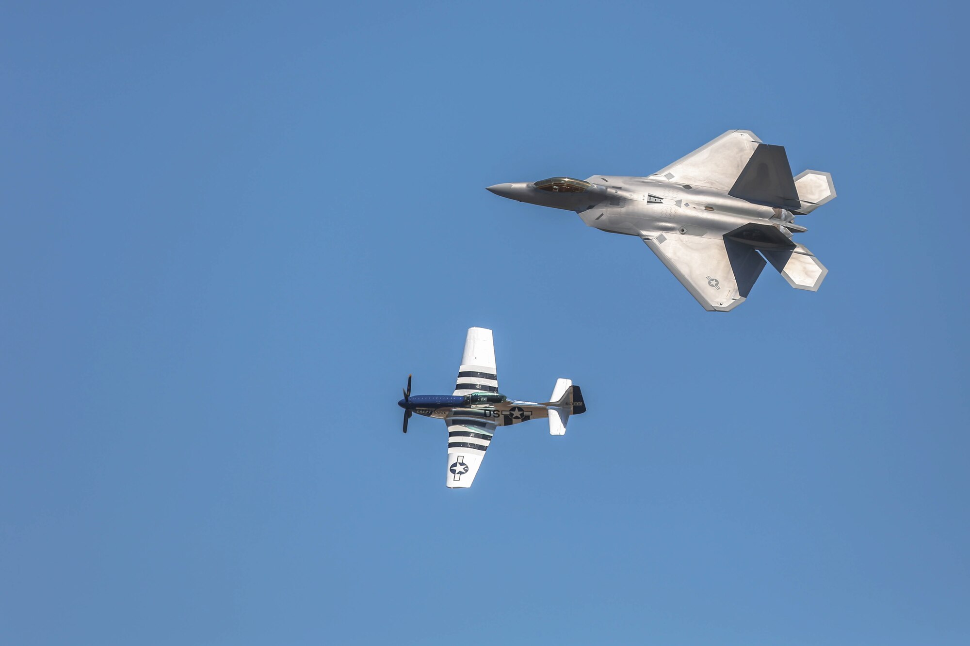 Approximately 100,000 people turned out to Robins Air Force Base to witness the 2012 Air Show. An aerial demonstration called the Heritage Flight mixed the old with the new -- a side-by-side flight by the F-22 Raptor and the P-51 Mustang. (U.S. Air Force photo by 1st Lt. Joel Cooke)