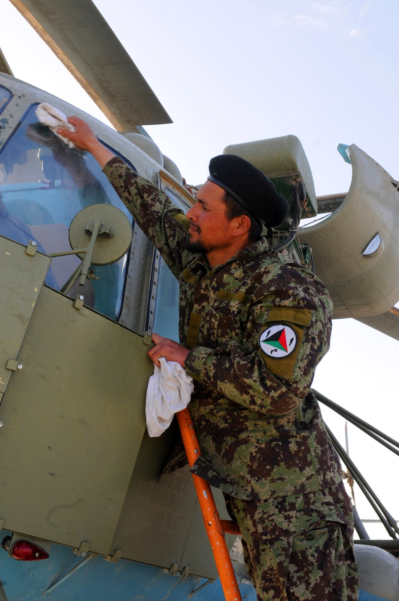 An Afghan air force airman wipes the window of an Afghan Mi-17 Helicopter prior to a scheduled training flight at Kandahar Air Base, Afghanistan, April 17, 2012. (U.S. Air Force photo by Staff Sgt. Nadine Y. Barclay)