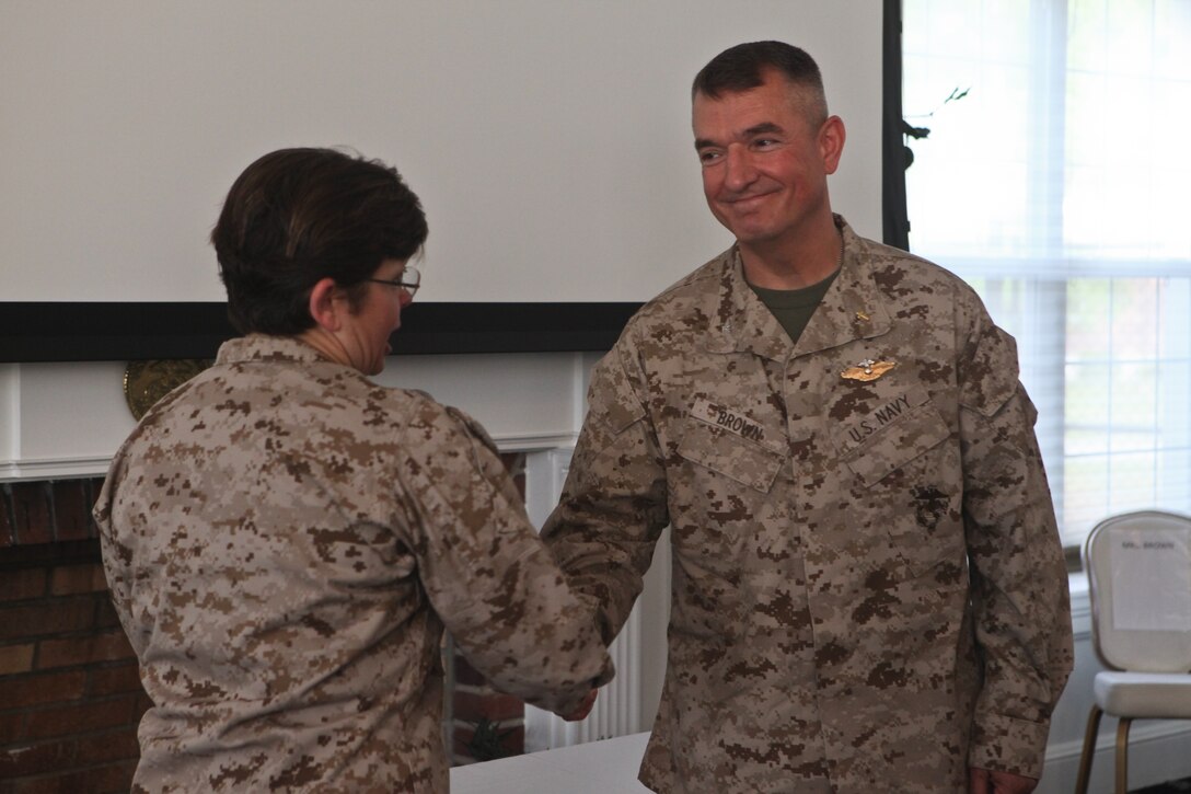 Warrington, Pa., native Rear Adm. Margaret G. Kibben, the chaplain of the Marine Corps, congratulates Lake Orion, Mich., native Navy Capt. Steven Brown on being awarded the John H. Craven Servant Leadership Award.  Brown was presented the award for his accomplishments as the chaplain for II Marine Expeditionary Force (Forward) in Afghanistan.