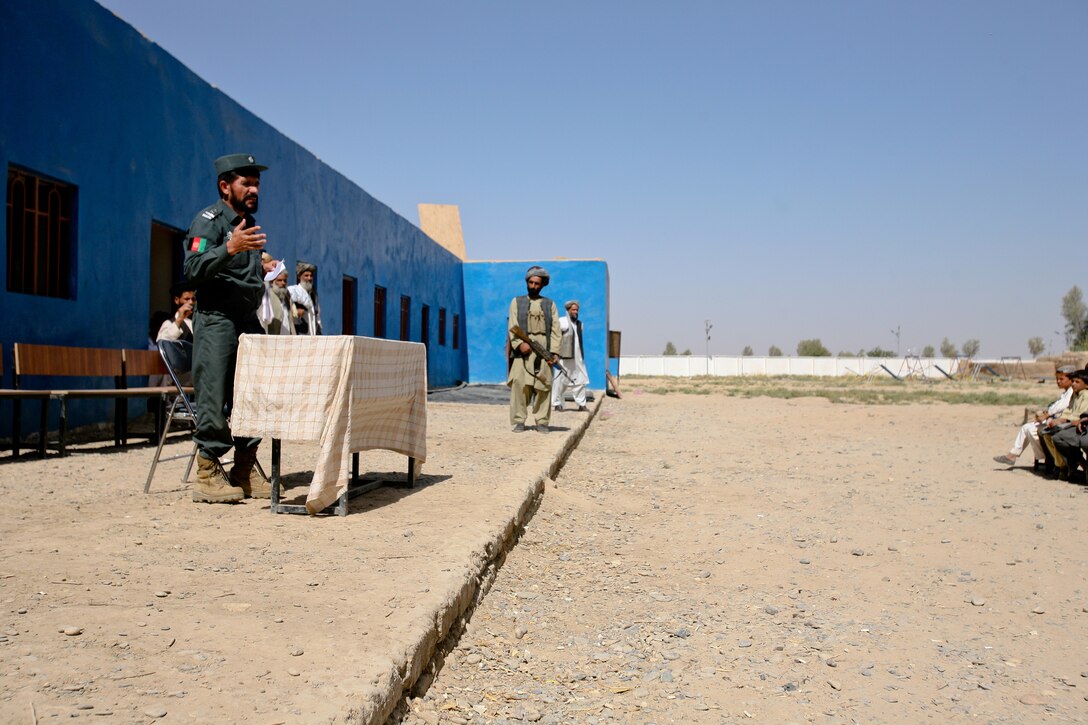Ahmad Marjan, a local Afghan Uniformed Police commander in Marjah, speaks to local residents and students at the opening day ceremonies of the Balakino School recently. The local Afghan National Security Force leaders are large contributors in the opening of new schools, and they ensure elders and headmasters are working through the Afghan government’s ministry of education to facilitate resources for the schools.