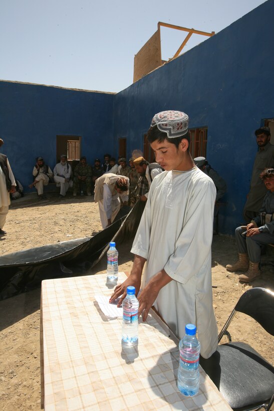 A student of the Balakino School performs a reading for the crowd gathered to celebrate the school’s opening day ceremony recently. There are more than 600 registered students at the Balakino School, a tremendous success for the area once ruled by insurgents who did not allow schools.