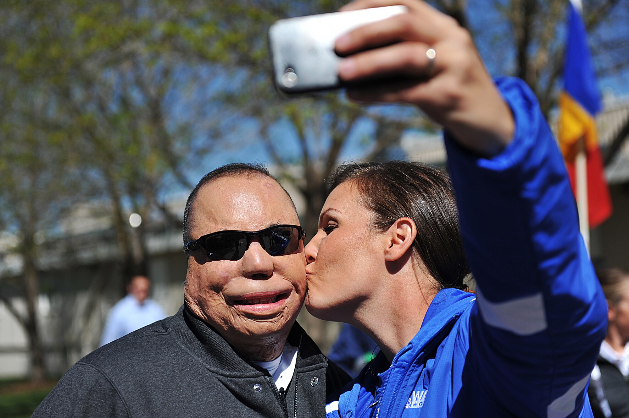 U.S. Air Force (USAF) Tech. Sgt. Israel Del Toro, left, receives a kiss from retired USAF Staff Sgt. Stacy Pearsall as she takes their photograph before the opening ceremony of Warrior Games 2012 at Colorado Springs, Colo., May 1, 2012. Del Toro is with the Special Operations team and Pearsall is with the Air Force team. (U.S. Air Force photo by Val Gempis/Released)