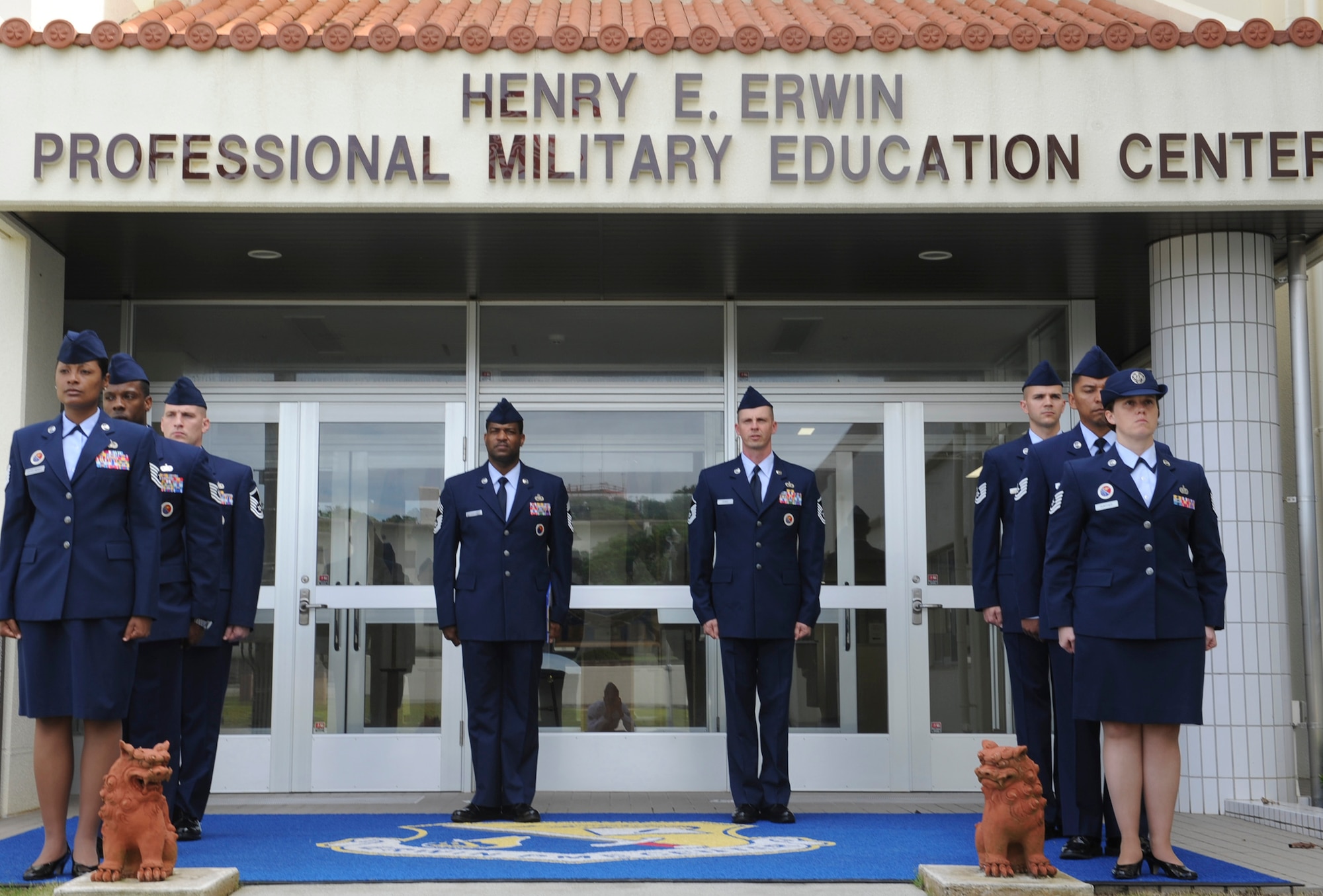 Members of the Erwin Professional Military Education Center staff stand at attention after an NCO Academy uniform inspection at Kadena Air Base, Japan, April 30, 2012.The Erwin PME Center provides professional military education to about 500 technical sergeants every year to prepare them for leading and managing Airmen within their units. (U.S. Air Force photo/Airman 1st Class Justin Veazie)