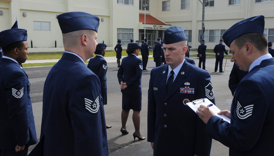 U.S. Air Force Master Sgt. Christopher Dreisbach, Erwin Professional Military Education Center faculty superintendent, inspects members of the NCO Academy Class 12-4 during a service dress uniform inspection at Kadena Air Base, Japan, April 30, 2012. Dreisbach has been an NCOA instructor for more than a year and completed more than 24 inspections for eight graduating classes. (U.S. Air Force photo/Airman 1st Class Justin Veazie)