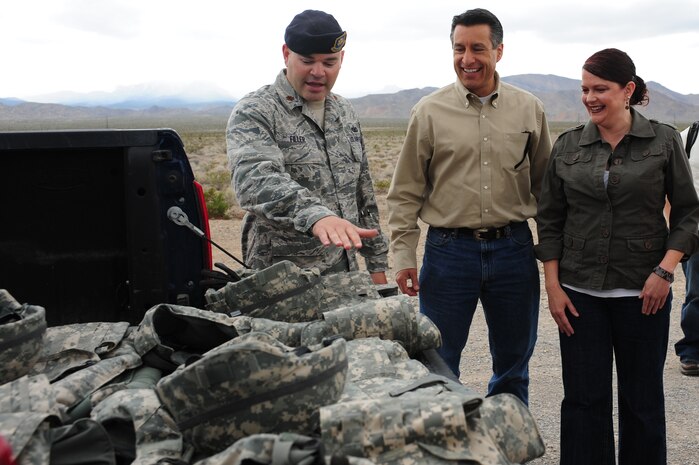 U.S Air Force Major Brian Filler, Commander, 99th Ground Combat Training Squadron briefs the Nevada Governor Brian Sandoval and First Lady Kathleen Sandoval, on wearing protective gear April 25, 2012, at the Nevada Test and Training Range.  The Sandovals spent their day learning about operations conducted at Nellis and Creech Air Force Bases, as well as on the NTTR.  (U.S. Air Force photo by Airman 1st Class Christopher Tam)