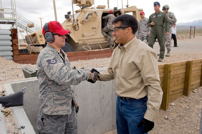 Nevada Governor Brian Sandoval thanks U.S. Air Force Staff Sgt. Jonathan Blair, 99th Ground Combat Training Squadron combat arms instructor, for instruction on the use of the M-240B machine gun, April 25, 2012, at the Nevada Test and Training Range.  Governor Sandoval and his wife, Nevada First Lady, Kathleen, spent their day meeting Airmen stationed at Creech and Nellis Air Force Bases. (U.S. Air Force photo by Staff Sgt. William P. Coleman)