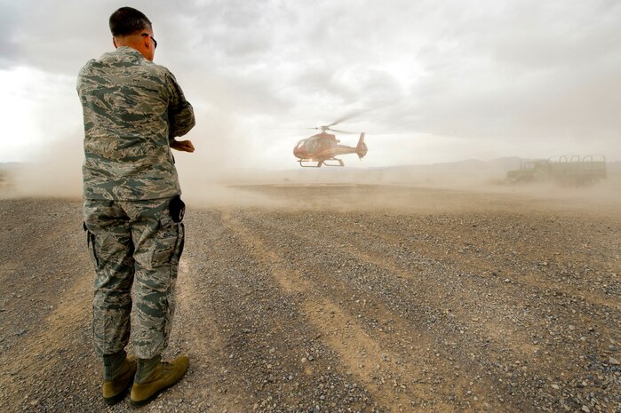 Colonel Henri Lambert, Commander, 99th Security Forces Group, marshals in a helicopter carrying Nevada Governor Brian Sandoval, April 25, 2012, at the Nevada Test and Training Range.  The governor toured different areas of NTTR, as well as Creech and Nellis Air Force Bases, to learn about mission operations and meet Airmen. (U.S. Air Force photo by Staff Sgt.
William P. Coleman)
