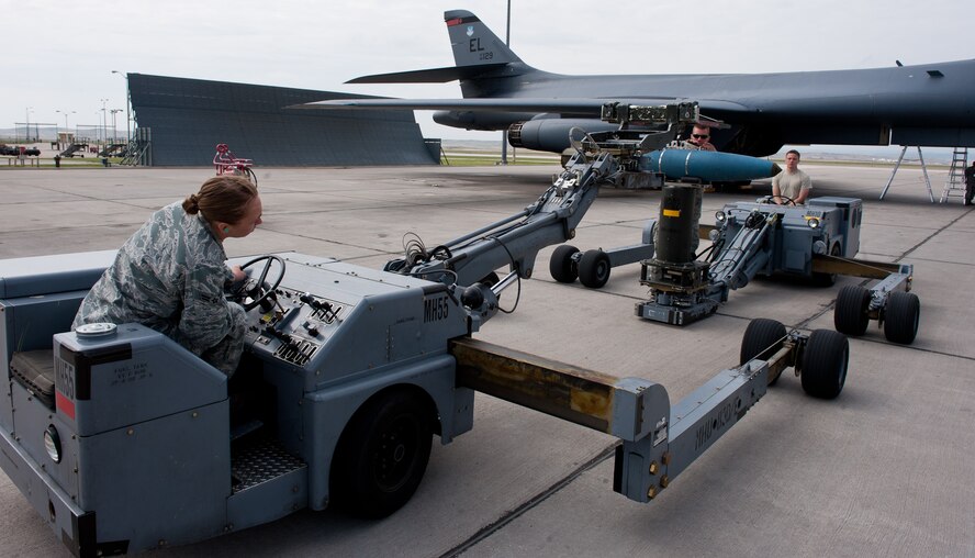 (From left) Airman 1st Class Kesha Denny, Airman 1st Class Eric Willey and Senior Airman Preston Stucky, 28th Aircraft Maintenance Squadron weapons load-crew members, transfer a Mark 82 high-drag bomb from a bomb jammer to a fork adapter after unloading it from a B-1 on the flightline at Ellsworth Air Force Base, S.D., April 26, 2012. The weapons flight Airmen make the B-1 Bomber’s combat operations possible by loading necessary munitions. (U.S. Air Force photo by Airman 1st Class Kate Thornton/Released)