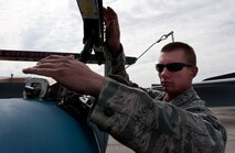 Airman 1st Class Eric Willey, 28th Aircraft Maintenance Squadron weapons load-crew member, secures a Mark 82 high-drag bomb to a fork adapter to transfer it to an MHU 110 munitions trailer after unloading it from a B-1 on the flightline at Ellsworth Air Force Base, S.D., April 26, 2012. The weapons flight ensures that every bomb is handled properly. (U.S. Air Force photo by Airman 1st Class Kate Thornton/Released)