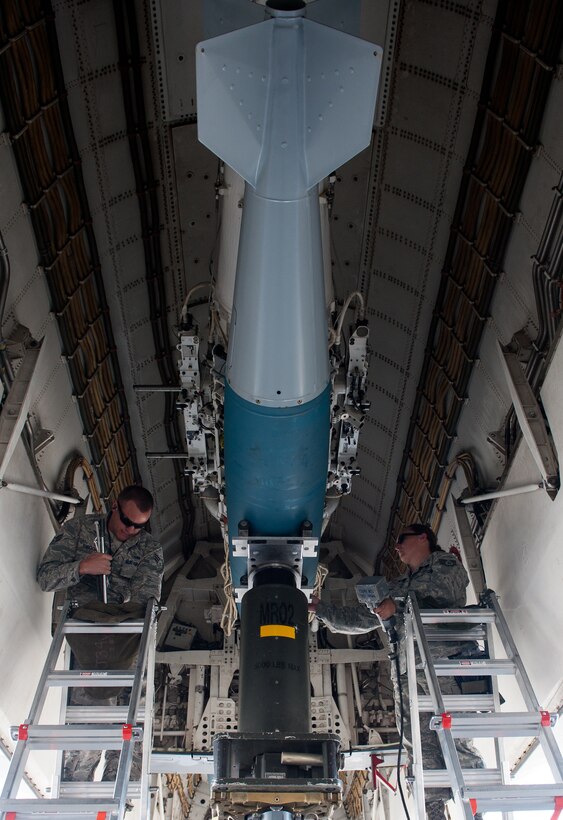 Senior Airman Brian Arbogast (left) and SSgt Nicole Tauzin, 28th Aircraft Maintenance Squadron weapons load-crew, prepare to unload a BD-56 bomb from a B-1 on the flightline at Ellsworth Air Force Base, S.D., April 26, 2012. The weapons flight is responsible for loading munitions in preparation for flying. (U.S. Air Force photo by Airman 1st Class Kate Thornton/Released)