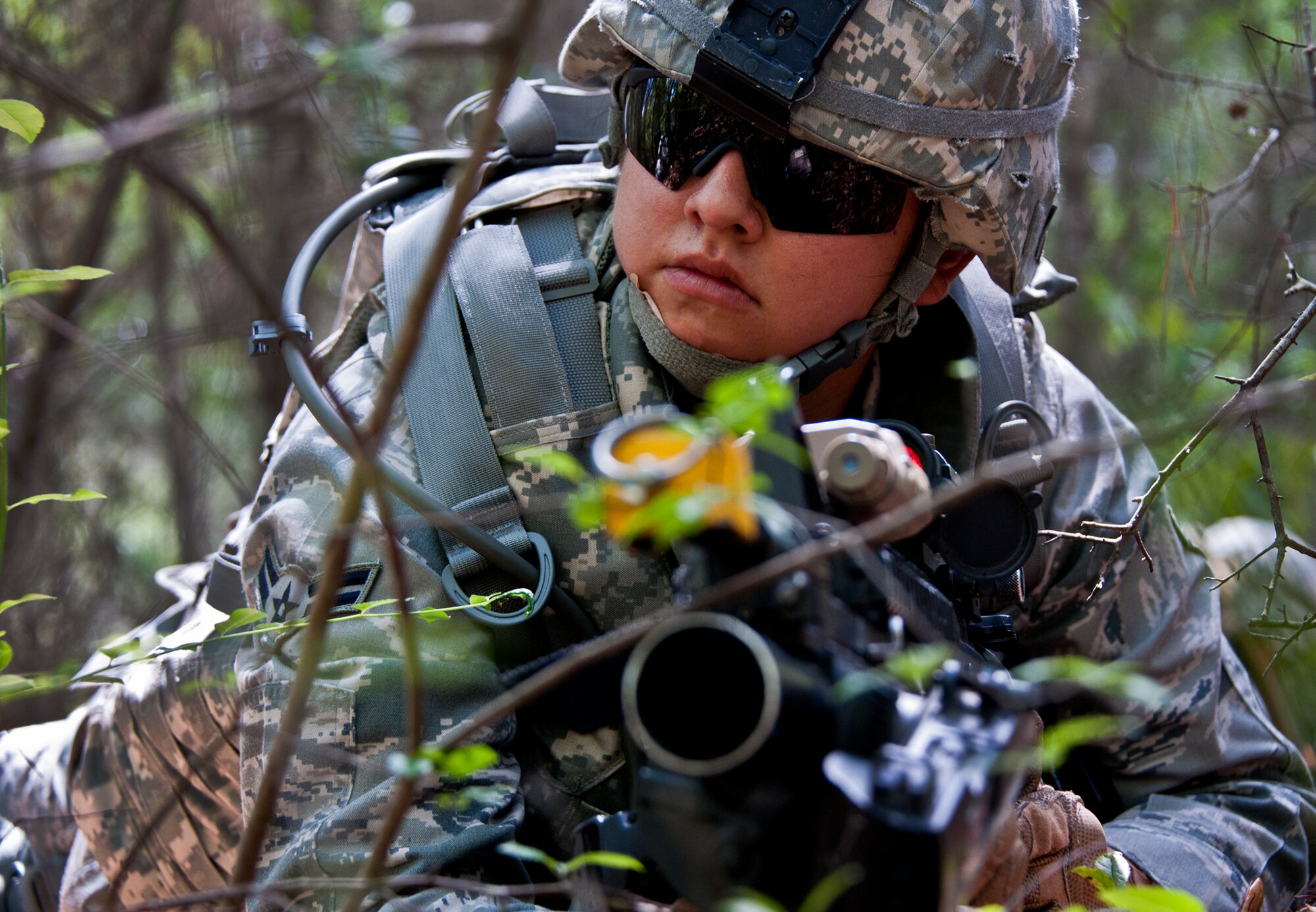 Airman 1st Class LaSondra Arredondo, of the 49th Security Forces Squadron, checks her right side during the three-day Brave Defender field training exercise April 27 at Eglin Air Force Base, Fla.  The exercise is the culmination of Air Force Materiel Command’s six-week security forces deployment training, administered by the 96th Ground Combat Training Squadron. GCTS instructors teach 10 training classes a year, which consists of improvised explosive device detection and reaction, operating in an urban environment, mission planning, land navigation, casualty care and more. More than 100 active-duty and National Guard Airmen attended this training. (U.S. Air Force photo/Samuel King Jr.)