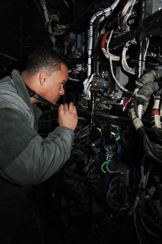 U.S. Air Force Senior Airman Josue Arroyo, 27th Special Operations Aircraft Maintenance Squadron crew chief, inspects a system on the AC-130H Spectre gunship on the flightline at Cannon Air Force Base, N.M., Feb. 21, 2012. The system maintains several other systems which are critical to overall functionality of the aircraft. (U.S. Air Force photo by Senior Airman Jette Carr)  