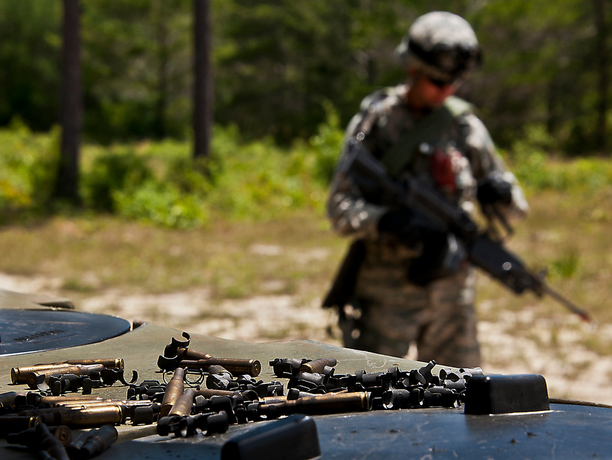 Reminders of the night’s firefight are still visible as Airman 1st Class Ryan Moulton, of the 49th Security Forces Squadron, checks his weapon before his patrol during the three-day Brave Defender field training exercise April 27 at Eglin Air Force Base, Fla.  The exercise is the culmination of Air Force Materiel Command’s six-week security forces deployment training, administered by the 96th Ground Combat Training Squadron. GCTS instructors teach 10 training classes a year, which consists of improvised explosive device detection and reaction, operating in an urban environment, mission planning, land navigation, casualty care and more. More than 100 active-duty and National Guard Airmen attended this training. (U.S. Air Force photo/Samuel King Jr.)