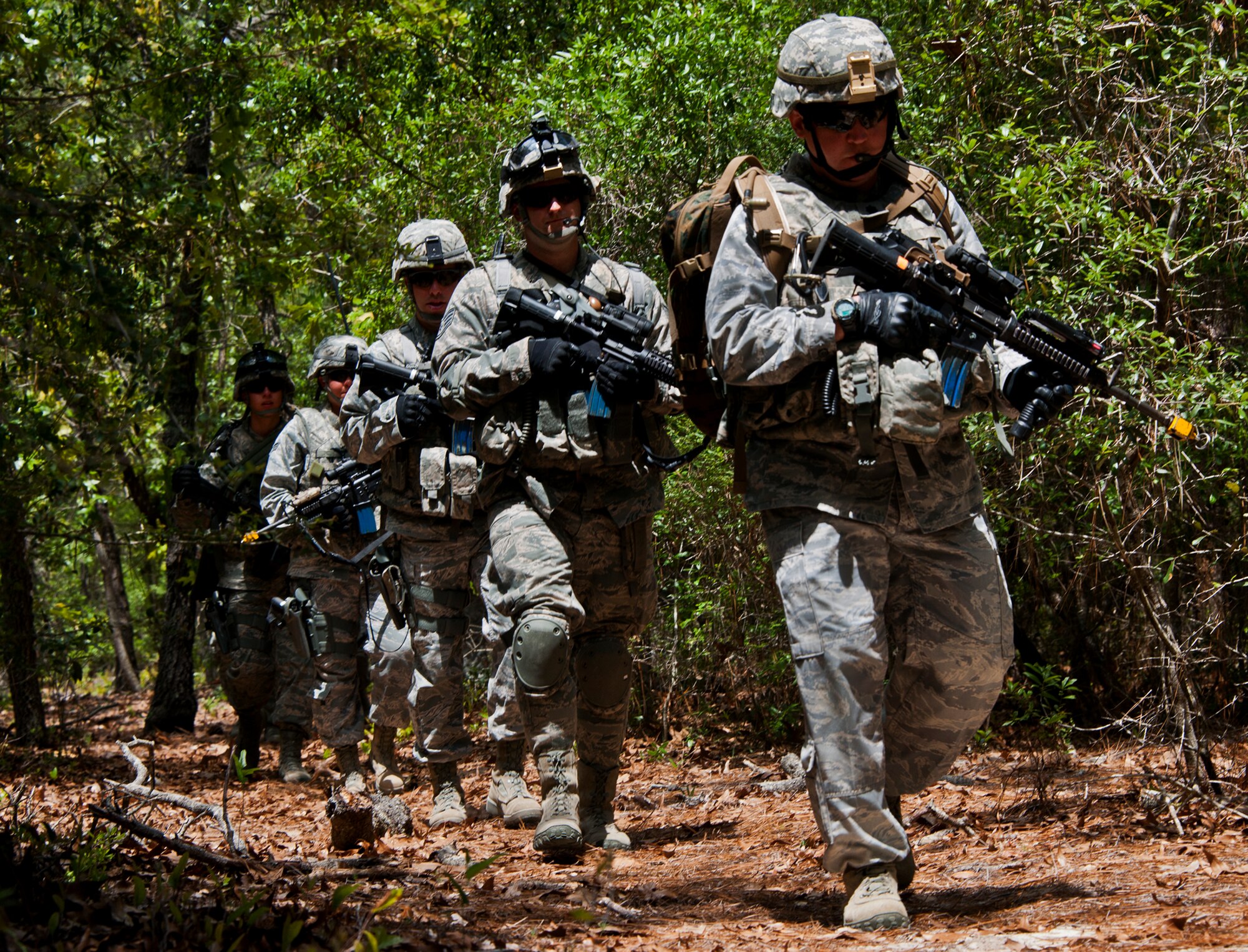 Lt. Col. Scott Foley, the 633rd Security Forces Squadron commander, moves through the woods of Eglin Air Force Base, Fla., in search of a weapons cache during the three-day Brave Defender field training exercise April 27.  The exercise is the culmination of Air Force Materiel Command’s six-week security forces deployment training, administered by the 96th Ground Combat Training Squadron. GCTS instructors teach 10 training classes a year, which consists of improvised explosive device detection and reaction, operating in an urban environment, mission planning, land navigation, casualty care and more. Foley, the former commander of the 96th Security Forces Squadron was just one of more than 100 active-duty and National Guard Airmen attended this training.  (U.S. Air Force photo/Samuel King Jr.)