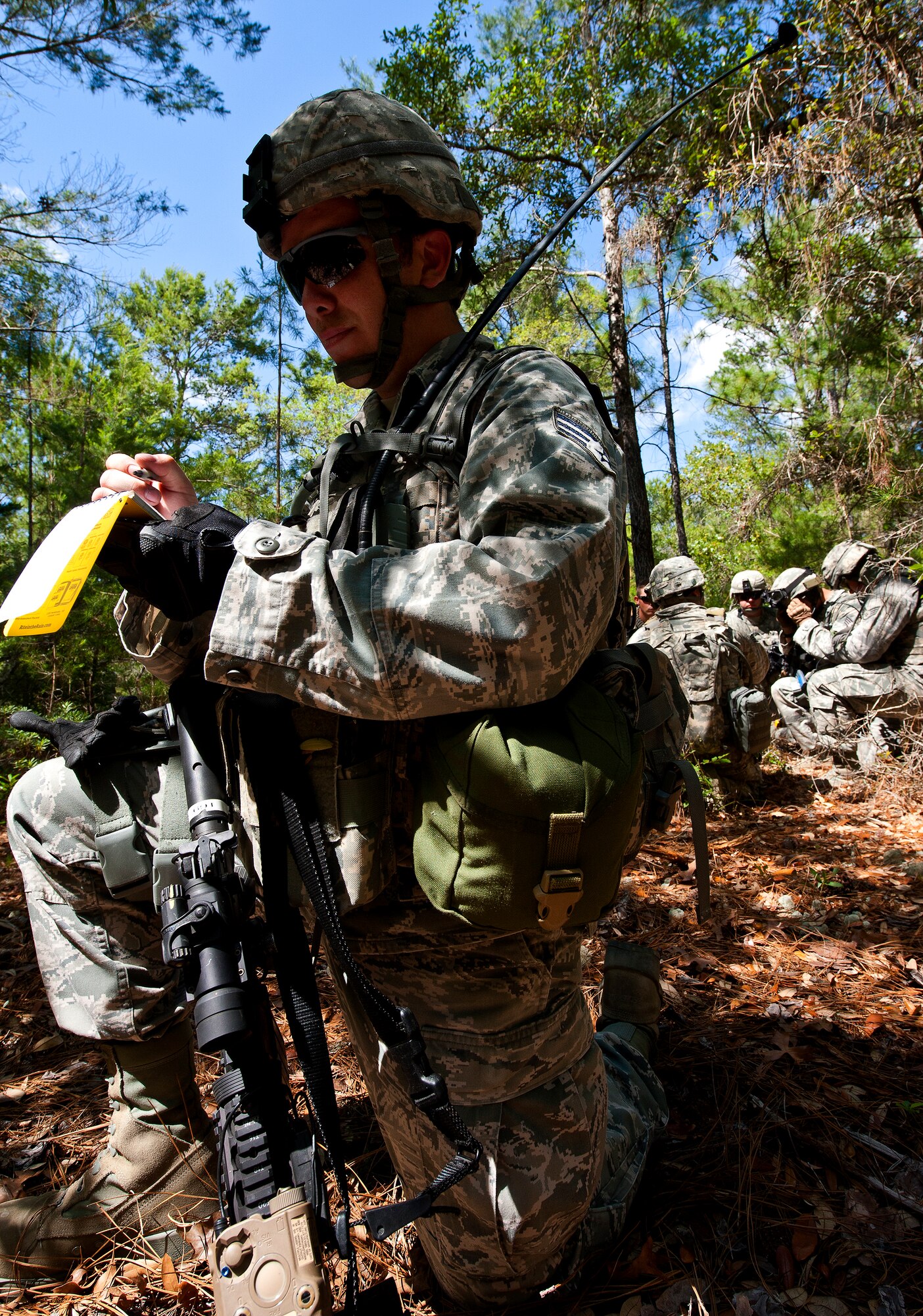 Senior Airman Travis Turner, of the 49th Security Forces Squadron, takes notes regarding the movements of his squad during a patrol at the three-day Brave Defender field training exercise April 27 at Eglin Air Force Base, Fla.  The exercise is the culmination of Air Force Materiel Command’s six-week security forces deployment training, administered by the 96th Ground Combat Training Squadron. GCTS instructors teach 10 training classes a year, which consists of improvised explosive device detection and reaction, operating in an urban environment, mission planning, land navigation, casualty care and more. More than 100 active-duty and National Guard Airmen attended this training. (U.S. Air Force photo/Samuel King Jr.)