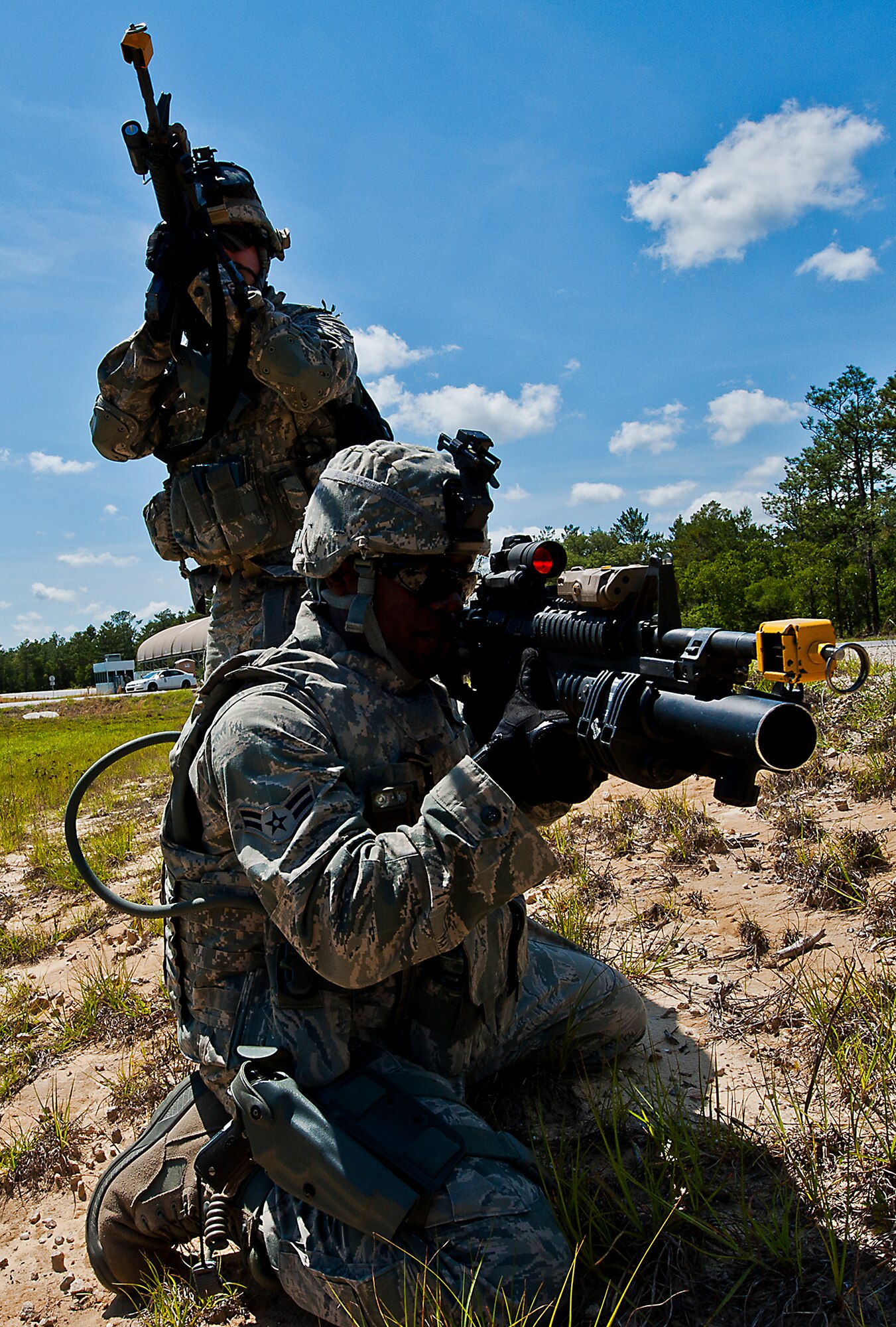 Airman 1st Class Dwayne Martin and another Airman from the 49th Security Forces Squadron, cover high and low as their squad moves across the road during a patrol at the three-day Brave Defender field training exercise April 27 at Eglin Air Force Base, Fla.  The exercise is the culmination of Air Force Materiel Command’s six-week security forces deployment training, administered by the 96th Ground Combat Training Squadron. GCTS instructors teach 10 training classes a year, which consists of improvised explosive device detection and reaction, operating in an urban environment, mission planning, land navigation, casualty care and more. More than 100 active-duty and National Guard Airmen attended this training. (U.S. Air Force photo/Samuel King Jr.)