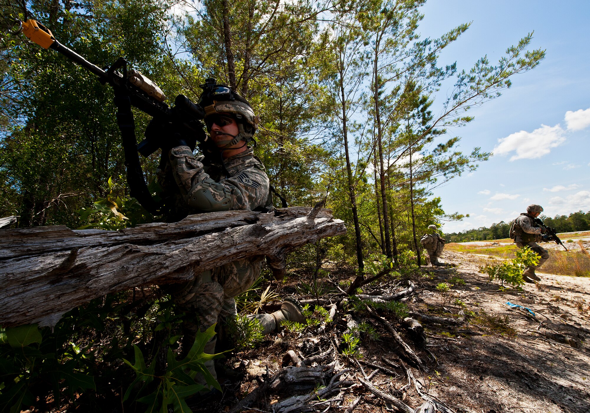 Staff Sgt. Joshua Sampson, of the 49th Security Forces Squadron, covers his squad as they cross the road during a patrol at the three-day Brave Defender field training exercise April 27 at Eglin Air Force Base, Fla.  The exercise is the culmination of Air Force Materiel Command’s six-week security forces deployment training, administered by the 96th Ground Combat Training Squadron. GCTS instructors teach 10 training classes a year, which consists of improvised explosive device detection and reaction, operating in an urban environment, mission planning, land navigation, casualty care and more. More than 100 active-duty and National Guard Airmen attended this training. (U.S. Air Force photo/Samuel King Jr.)