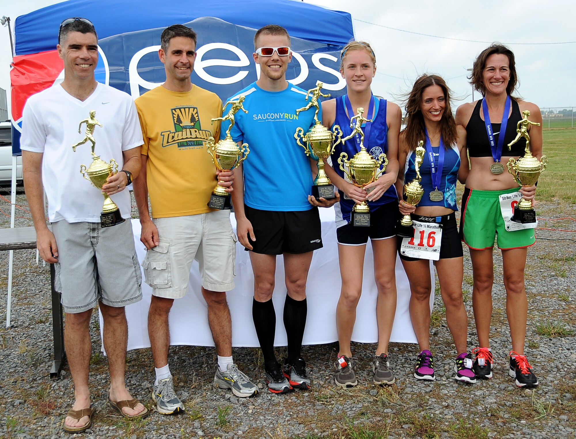 The winners of the Air Force Global Strike Command Striker Life Half Marathon pose together on Barksdale Air Force Base, La., April 28. Mark Davis and Brittany Dilley (center) won first place in the male and female categories, crossing the finish line at 1 hour, 25 minutes and 36.7 seconds and 1:41:41.1, respectively. Placing second in the male category was Chris Baird at 1:27:7.2, and third was Kenneth Rose at 1:33:49.5. The female second and third place winners were Tomi Swain at 1:47:17.4 and Melisha Thomas at 1:47:17.9, respectively. (U.S. Air Force photo/Staff Sgt. Amber Ashcraft)(RELEASED)