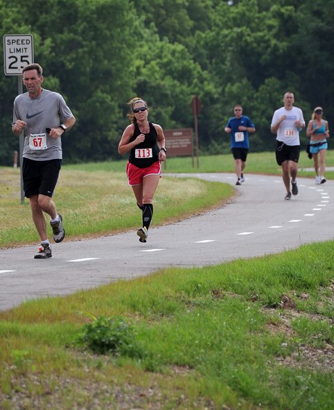 Team Barksdale members push toward the finish line of the Air Force Global Strike Command Striker Life Half Marathon on Barksdale Air Force Base, La., April 28. The first-ever marathon event held by the command was mapped at 13.1 miles through the East Reservation of base. (U.S. Air Force photo/Staff Sgt. Amber Ashcraft)(RELEASED)