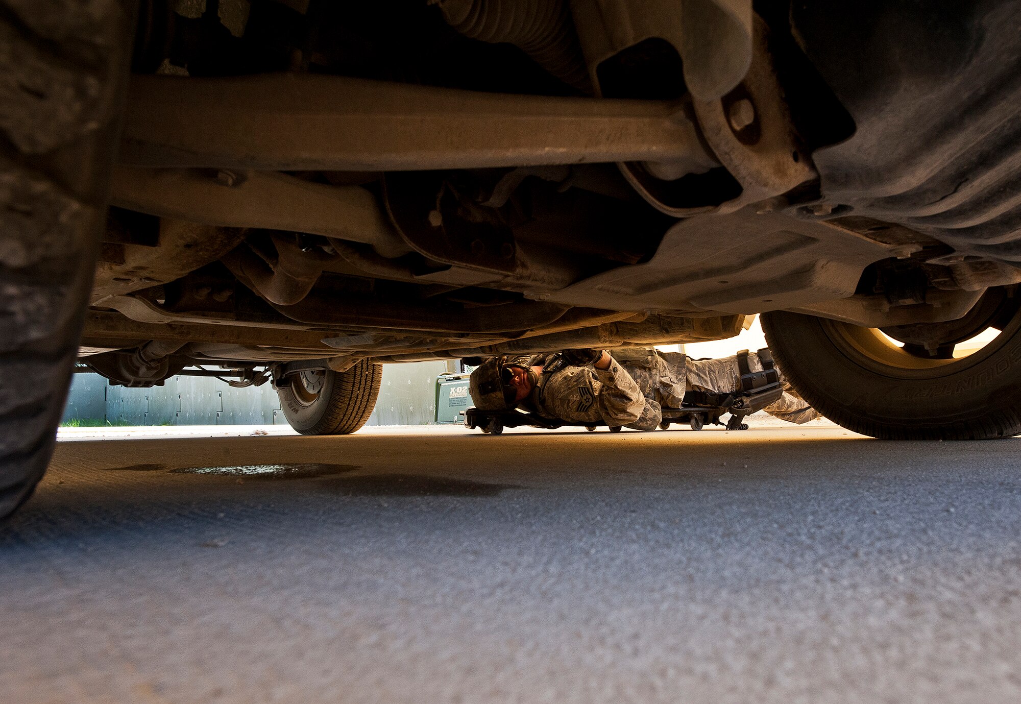 Staff Sgt. Kyle Larson, of the 802nd Security Forces Squadron, checks around the edges of a vehicle for suspicious materials during an inspection at the three-day Brave Defender field training exercise April 26 at Eglin Air Force Base, Fla.  The exercise is the culmination of Air Force Materiel Command’s six-week security forces deployment training, administered by the 96th Ground Combat Training Squadron. GCTS instructors teach 10 training classes a year, which consists of improvised explosive device detection and reaction, operating in an urban environment, mission planning, land navigation, casualty care and more. More than 100 active-duty and National Guard Airmen attended this training. (U.S. Air Force photo/Samuel King Jr.)