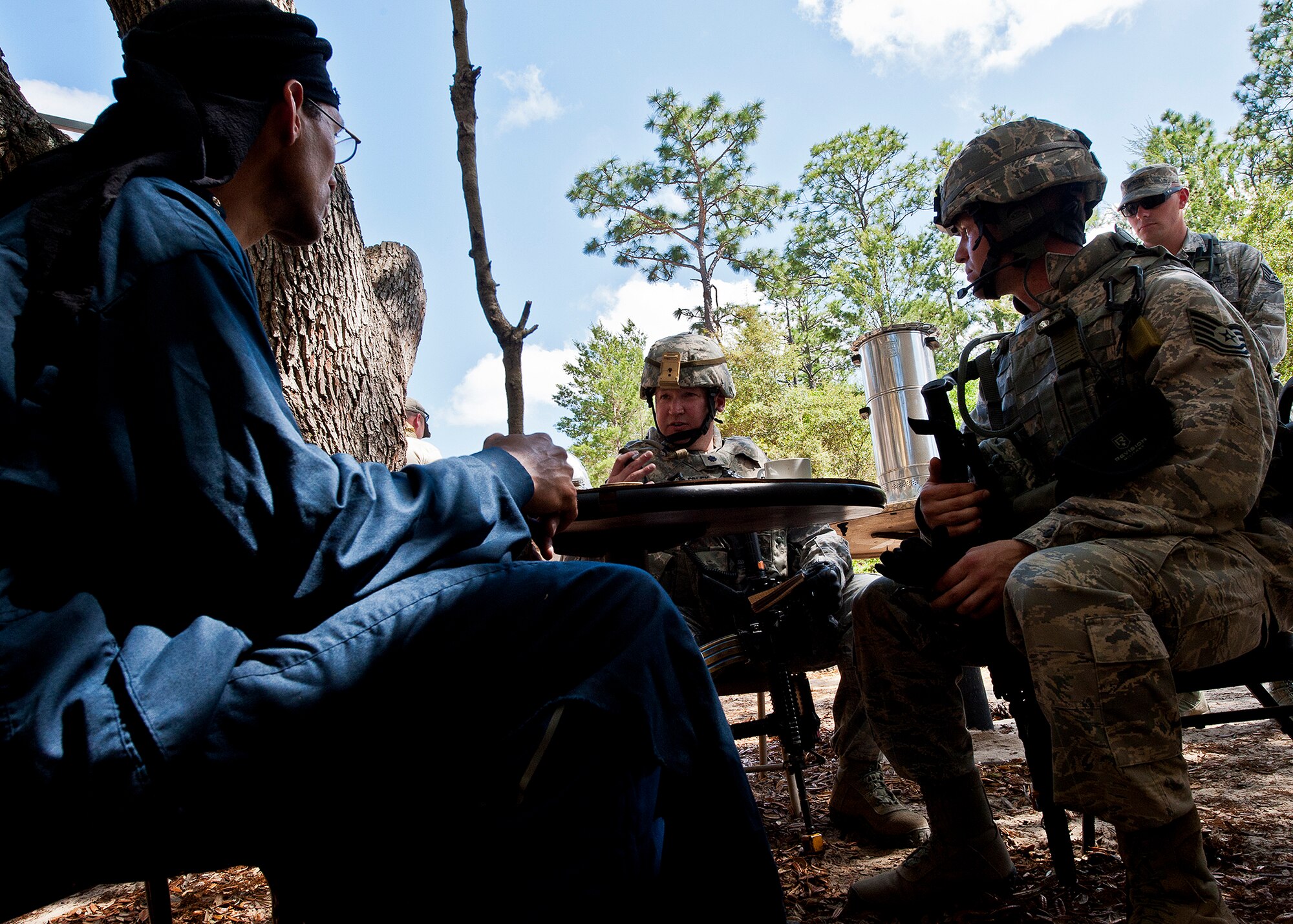 Lt. Col. Scott Foley, the 633rd Security Forces Squadron commander, speaks with the village elder on the first dismounted counter-insurgency operation of the three-day Brave Defender field training exercise April 26 at Eglin Air Force Base, Fla.  The exercise is the culmination of Air Force Materiel Command’s six-week security forces deployment training, administered by the 96th Ground Combat Training Squadron. GCTS instructors teach 10 training classes a year, which consists of improvised explosive device detection and reaction, operating in an urban environment, mission planning, land navigation casualty care and more. Foley, the former commander of the 96th Security Forces Squadron, was just one of more than 100 active-duty and National Guard Airmen to attend this training.  (U.S. Air Force photo/Samuel King Jr.)