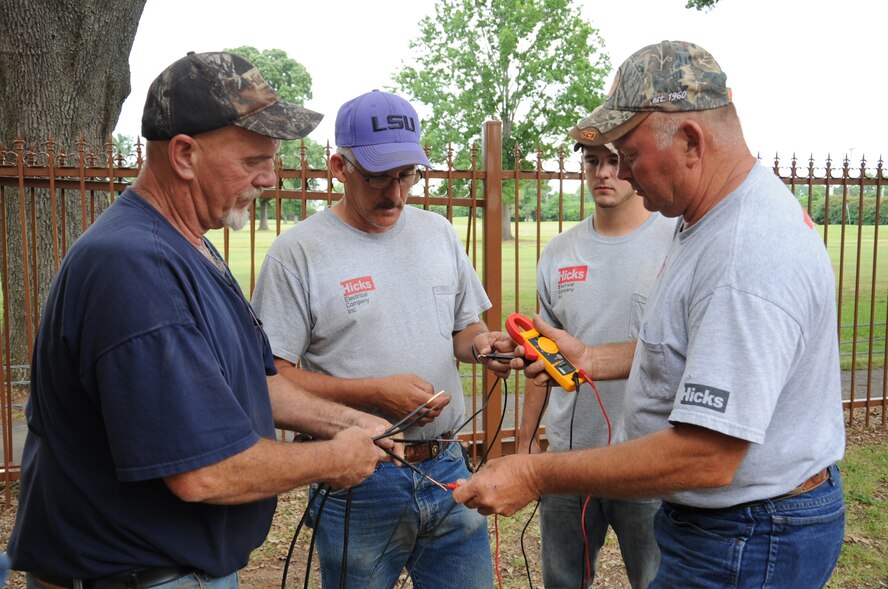 Members from a local construction company test the voltage of a set of wires during a construction project at the West Gate on Barksdale Air Force Base, La., April 30. The renovation project is scheduled to last 90 days. The project will include entrance and exit route upgrades, security enhancements and a new overhang. (U.S. Air Force photo/Senior Airman Sean Martin)(RELEASED)
