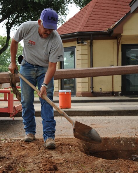Jeff Spillers, electrical foreman, fills in a hole with dirt during a construction project at the West Gate on Barksdale Air Force Base, La., April 30. The project, which will last 90 days, will provide a canopy for members of the 2nd Security Forces Squadron working at the gate. (U.S. Air Force photo/Senior Airman Sean Martin)(RELEASED)