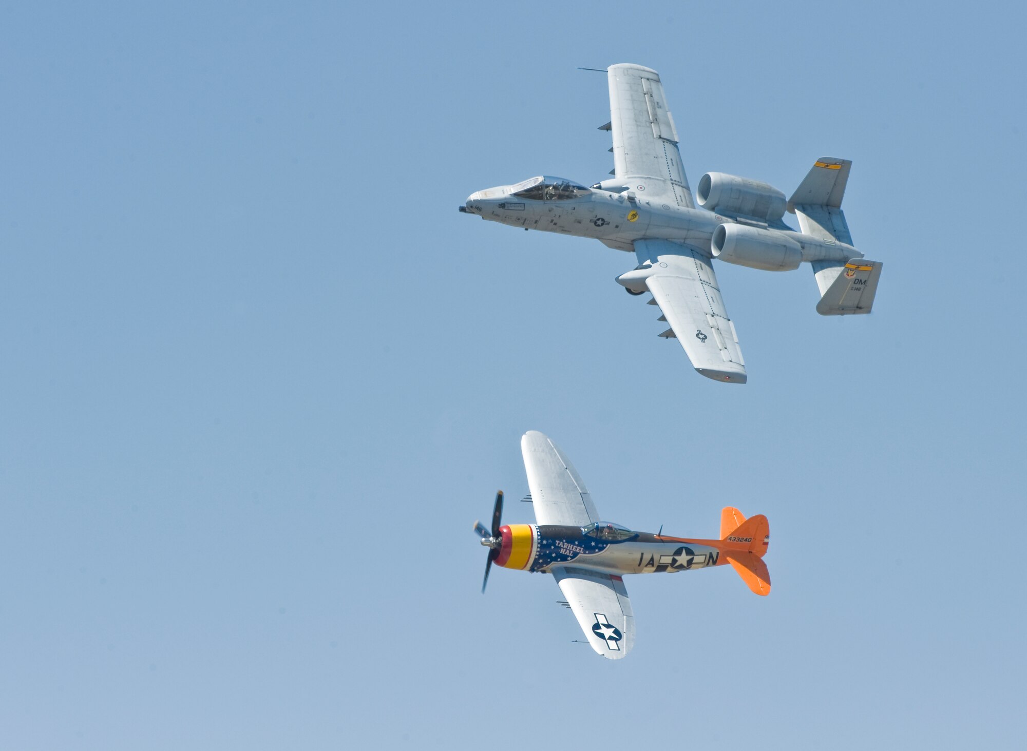 An A-10 Thunderbolt flies alongside a P-47 Thunderbolt during the Dyess Big Country Airfest April 28, 2012, at Dyess Air Force Base, Texas. The airfest displayed over 30 static aircrafts while also showcasing a B-2 Spirit, B-17, B-25 and many more. (U.S. Air Force photo by Airman 1st Class Jonathan Stefanko/ Released)