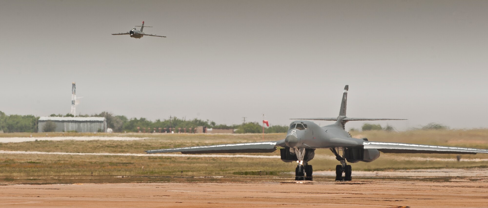 A MiG-17 flies past a B-1 Bomber during the Dyess Big Country Airfest April 28, 2012, at Dyess Air Force Base, Texas. The airfest displayed over 30 static aircrafts while also showcasing a B-2 Spirit, A-10 Thunderbolt, P-47 Thunderbolt and many more. (U.S. Air Force photo by Airman 1st Class Jonathan Stefanko/ Released)