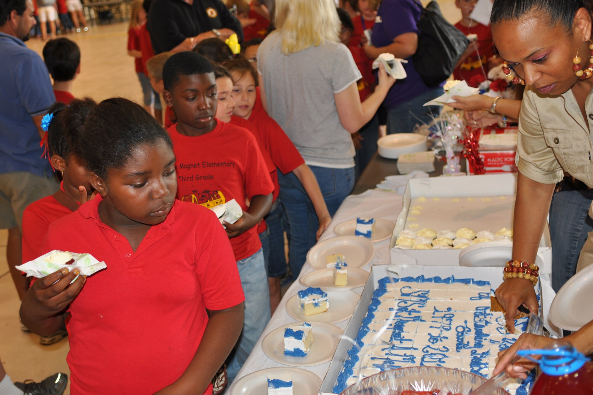 Phoenix Magnet Elementary School students try the refreshments following the retirement ceremony of one of their teachers, Senior Master Sgt. Margaret Maffett, Barksdale Air Force Base, La., April 27, 2012. Maffett retired from the Air Force Reserve after more than 30 years of service. (U.S. Air Force photo by Betty Stephens/Released)