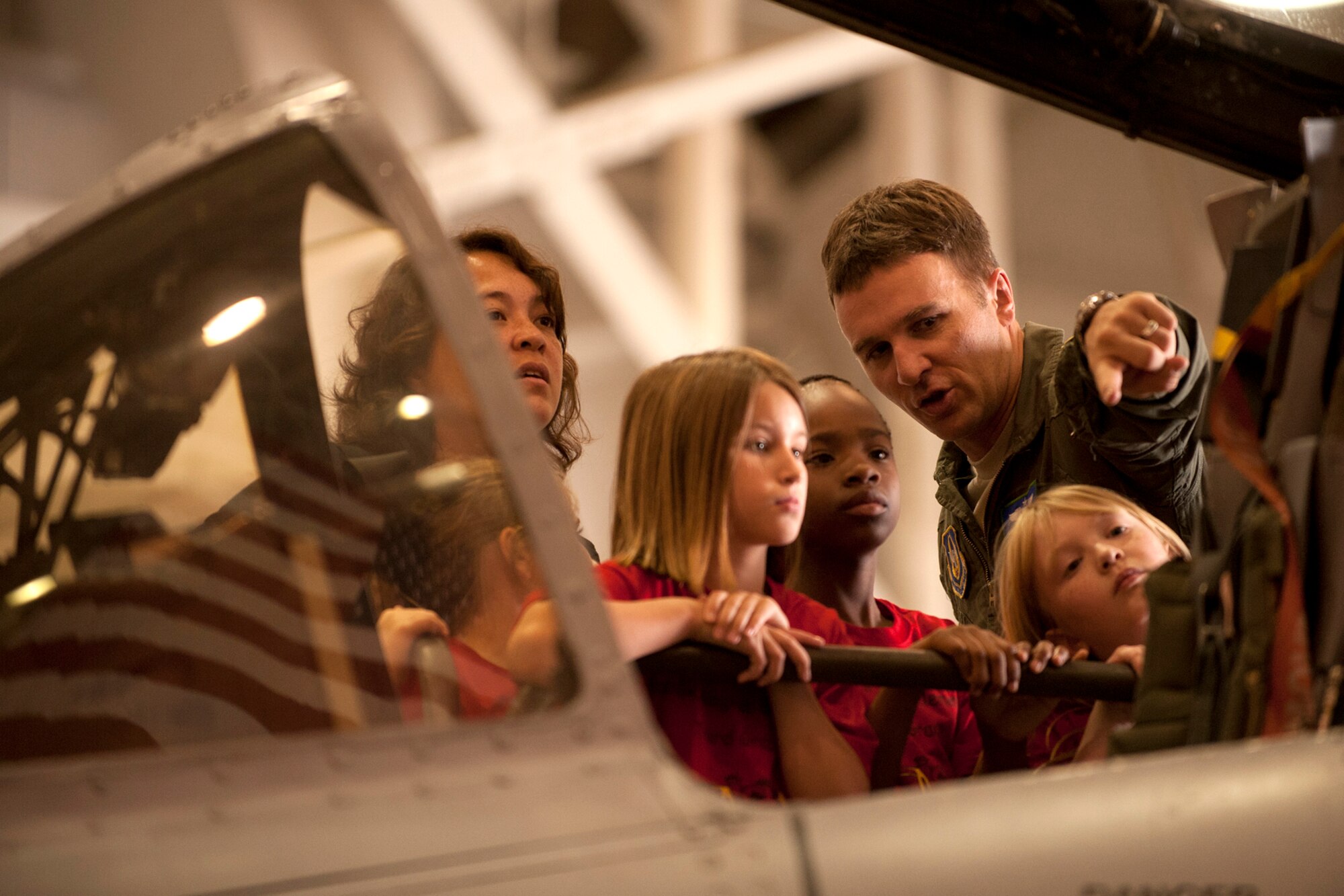 U.S. Air Force Maj. Jason Cobb, 47th Fighter Squadron pilot, shows Phoenix Magnet Elementary School students the cockpit of an A-10 Thunderbolt II during a tour at Barksdale Air Force Base, La., April 27, 2012. Students, parents and faculty members were treated to the tour following the retirement ceremony for one of their teachers, Senior Master Sgt. Margaret Maffett, 917th Aircraft Maintenance Squadron first sergeant, who retired from the Air Force Reserve after more than 30 years of service. (U.S. Air Force photo by Master Sgt. Greg Steele/Released)