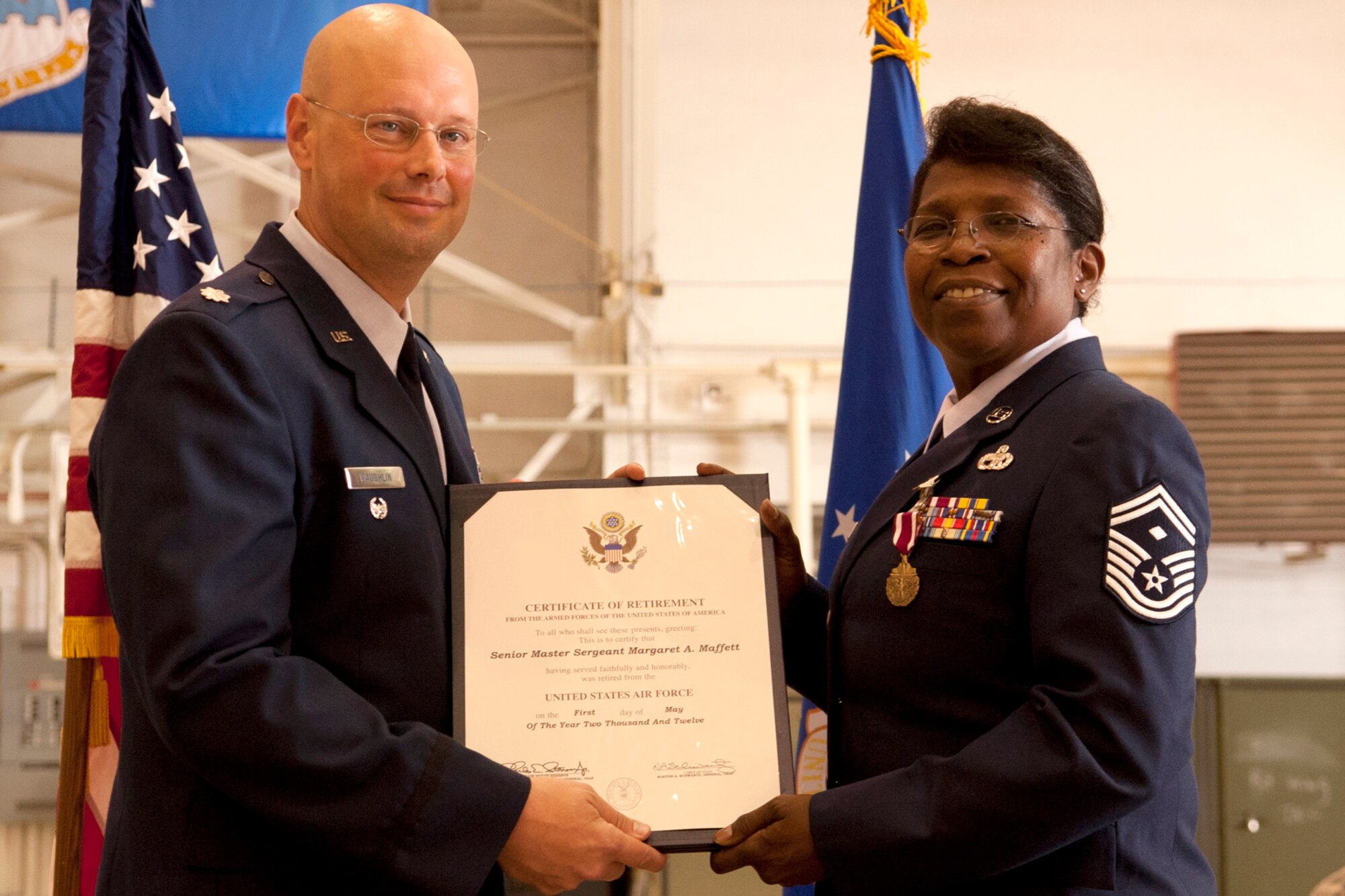U.S. Air Force Lt. Col. Travis Caughlin, 917th Fighter Group deputy commander for maintenance, presents the Certificate of Retirement to Senior Master Sgt. Margaret Maffett, 917th Aircraft Maintenance Squadron first sergeant, during a retirement ceremony, Barksdale Air Force Base, La., April 27, 2012. Maffett is retiring from the Air Force Reserve after more than 30 years of service. (U.S. Air Force photo by Master Sgt. Greg Steele/Released)