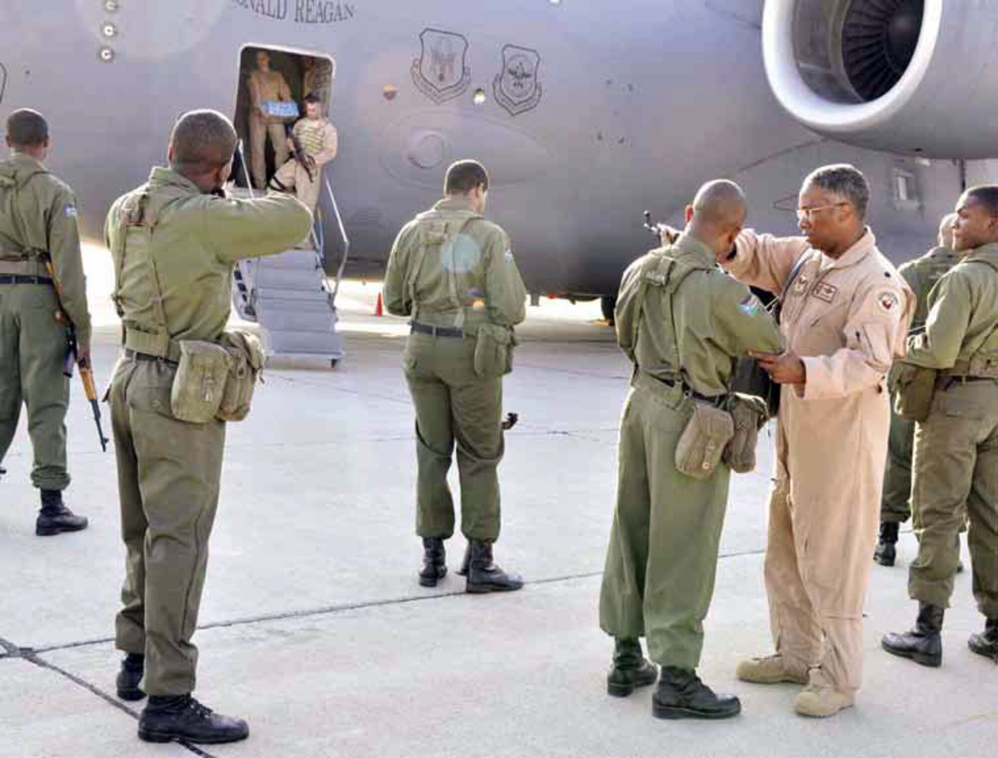 Lt. Col. Brian Chappelle, Deputy Director, Expeditionary Skills, Cultural and Language
Center, shows actors portraying Sudanese service members how to correctly aim their weapon, during filming for the Air Force’s Cultural and Language Center’s video series on cultural awareness, shot on base, March 21. (U.S. Air Force photo by SSgt Megan Crusher)