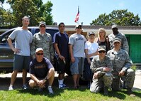 Airmen from Duke Field and Eglin Air Force Base pose for a group photo with Lucy Harstvedt , an Air Force widow (standing, third from right) and her daughter, Norma Jean Harstvedt, outside the elder Harstvedt’s former home in Shalimar, Fla., April 20.   The Airmen responded to a call for volunteers to help Lucy, widowed since 1964, relocate to the nearby Bob Hope Village, as she was unable to conduct the move.   Bob Hope Village, a retirement home for surviving spouses of Air Force enlisted members, is part of the overall non-profit Air Force Enlisted Village.  Duke volunteers shown are (standing from left): Staff Sgt. Jeremy Bubanas, 711th Special Operations Squadron;  Master Sgt. Randall Bell, 919th Maintenance Operaions Flight; and (kneeling, far left) Master Master Sgt. David Hahn, 711th SOS.  Eglin volunteers are (standing, beginning third from left): Master Sgt.  Angel Frasquillo, Tech. Sgt. Brad Richardson and Staff Sgt. Marcus Capers, all from the 33rd Aircraft Maintenance Squadron; and (kneeling, second from left) Master Sgts. Eli Bolin, 96th Logistics Readiness Squadron, and Mark Rosenblum, 33rd Maintenance Squadron.  (U.S. Air Force photo/Dan Neely)