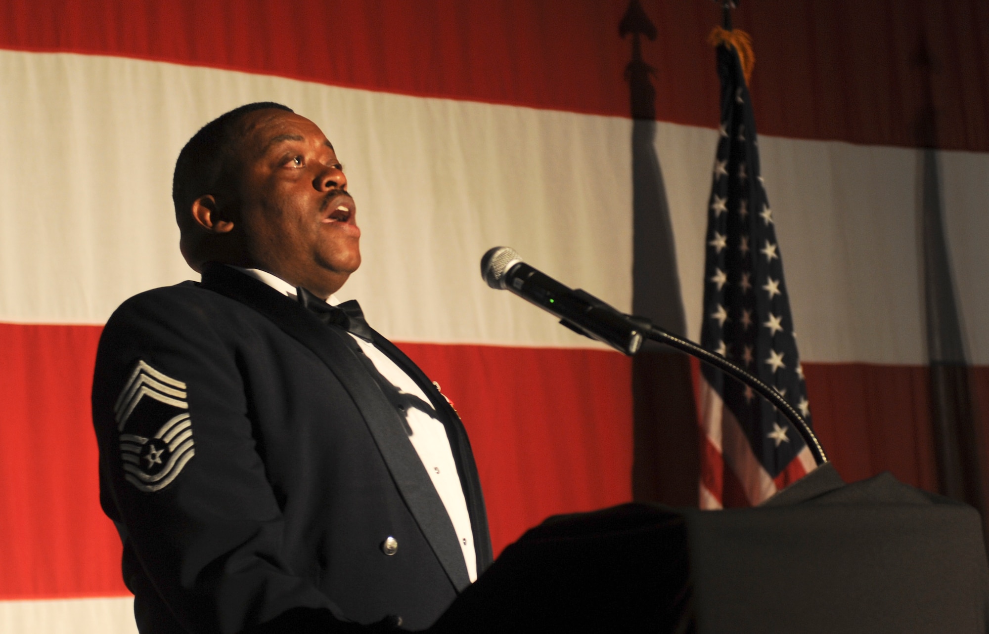 U.S. Air Force Retired Chief Master Sgt. Kenneth Lilly sings the National Anthem during the 2011 Maintenance Professional of the Year banquet at the James H. Rainwater Conference Center in Valdosta, Ga., April 26, 2012. The banquet was held to honor some of the Air Force’s best maintainers of the year. (U.S. Air Force photo by Airman 1st Class Douglas Ellis/Released)