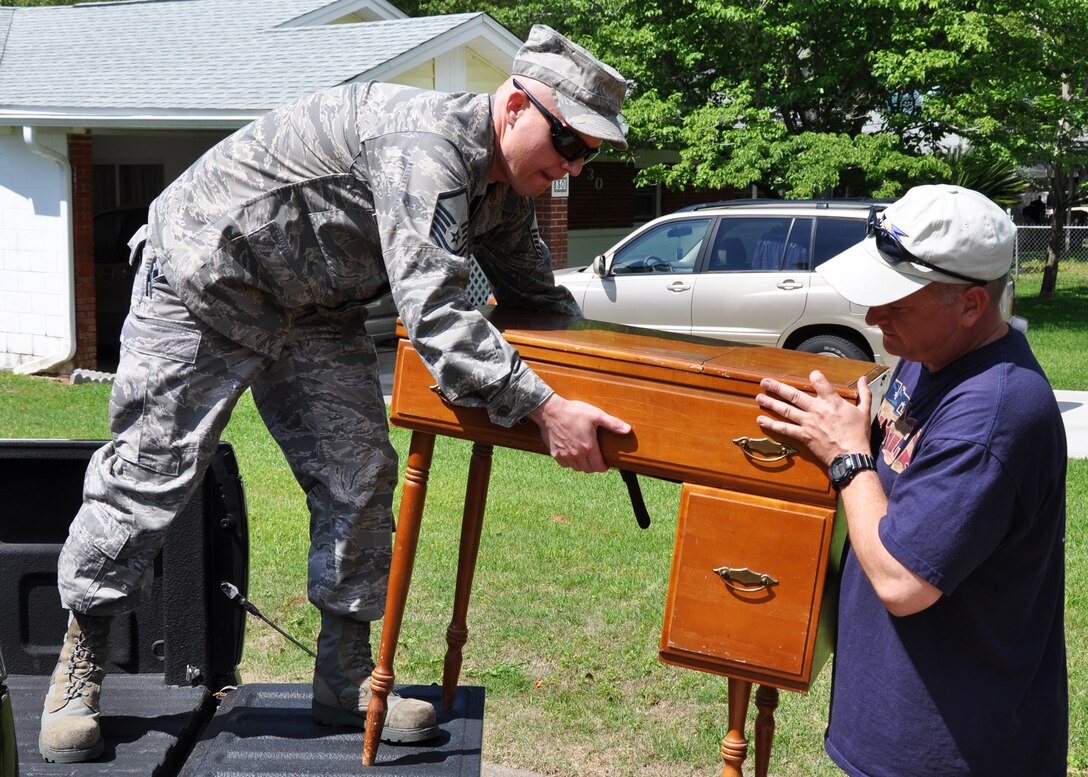 Master Sgts. Eli Bolin from the 96th Logistics Readiness Squadron at Eglin Air Force Base, left, and David Hahn from the 711th Special Operations Squadron at Duke Field, move a desk during a volunteer project in Shalimar, Fla., April 20. Eight Airmen responded to a call for volunteers to help Lucy Harstvedt, an Air Force widow since 1964, relocate to the nearby Bob Hope Village since she was unable to conduct the move. Bob Hope Village, a retirement home for surviving spouses of Air Force enlisted members, is part of the overall non-profit Air Force Enlisted Village. (U.S. Air Force photo/Dan Neely)