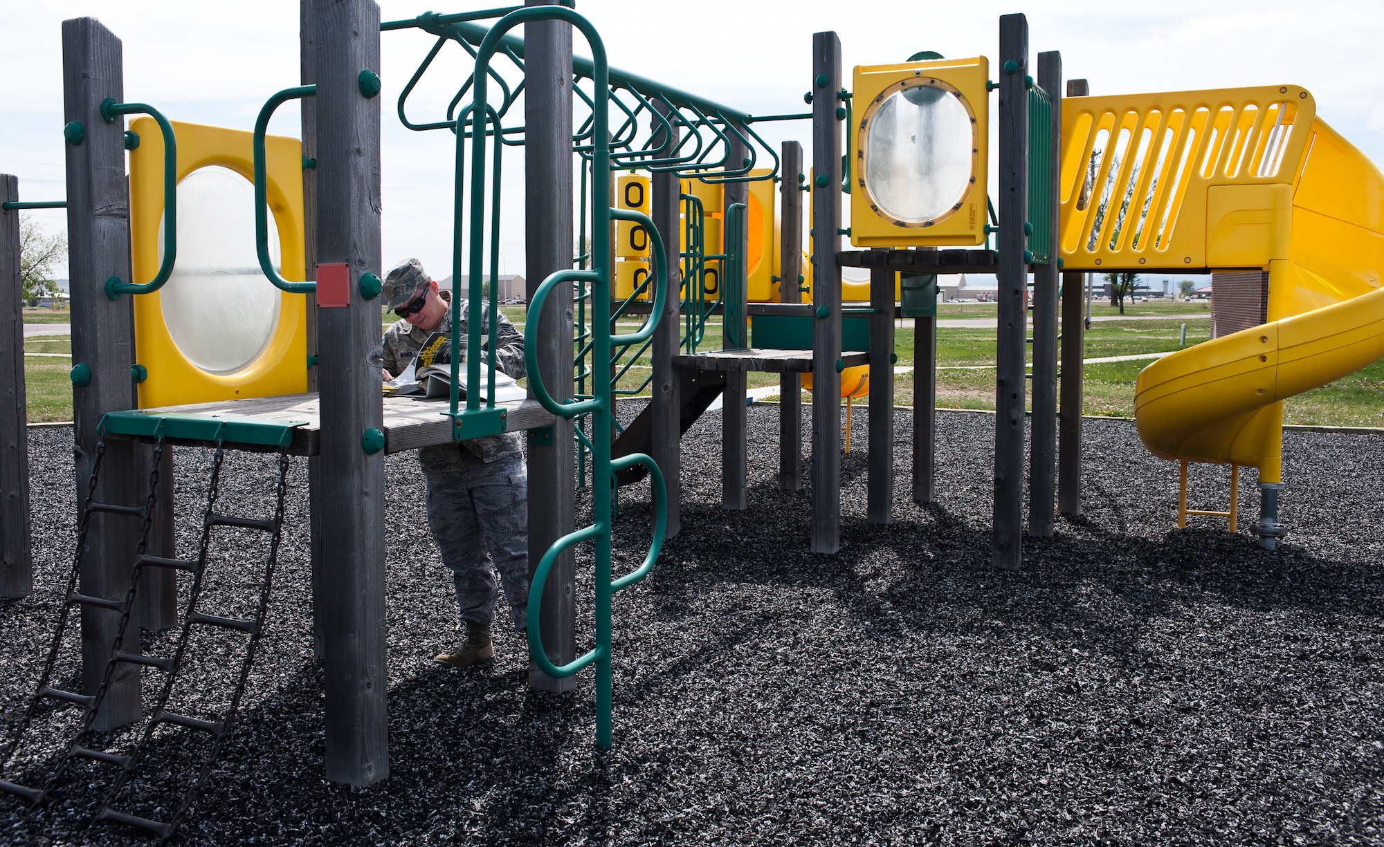 Staff Sgt. Francis Maher, 28th Bomb Wing ground safety technician, reviews playground safety guidelines to verify safety standards during an inspection on Ellsworth Air Force Base, S.D., April 26, 2012. The guidelines outline standards for playgrounds and parks to ensure they are suitable and safe for the children on base. (U.S. Air Force photo by Airman 1st Class Alystria Maurer/Released)