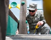 Staff Sgt. Francis Maher, 28th Bomb Wing ground safety technician, finds a loose piece of metal sheeting under playground equipment on Ellsworth Air Force Base, S.D., April 26, 2012. Ground safety specialists inspect the parks and playgrounds around the base to ensure they are safe for children to use. (U.S. Air Force photo by Airman 1st Class Alystria Maurer/Released)