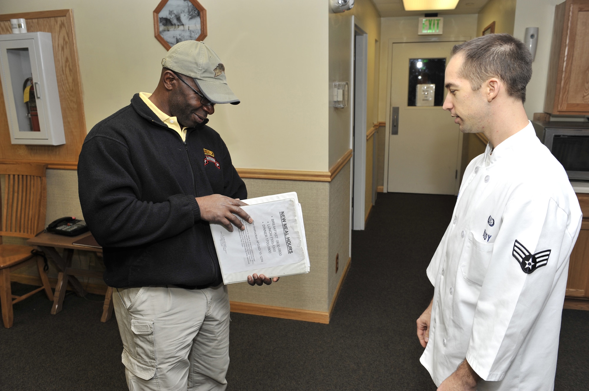 Senior Airman Jason Waddy, 490th Missile Squadron chef, waits for Mullen to make a meal selection on his visit to Oscar-01 Missile Alert Facility April 17. (U.S. Air Force photo/John Turner)