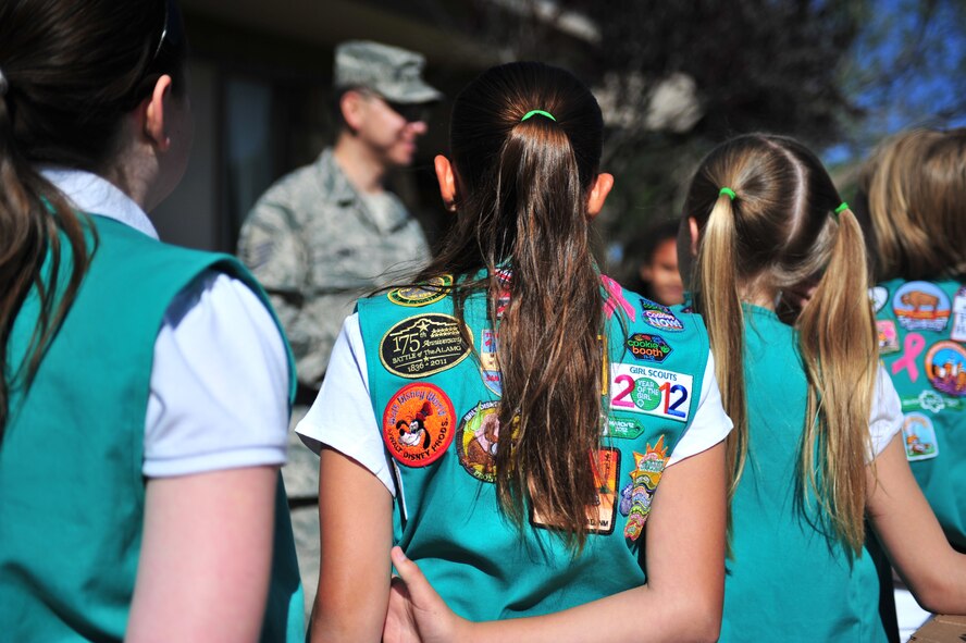 U.S. Air Force Master Sgt. Richard Gomez, 27th Special Operations Force Support Squadron, explains to the Girl Scouts of Texas and Oklahoma Plains in Lubbock, Texas, how much troops overseas will appreciate receiving cookies they donated April 28, 2012. The organization celebrates its 100th Anniversary this year and took pride in supporting military members worldwide. (U.S. Air Force photo by Airman 1st Class Alexxis Pons Abascal)