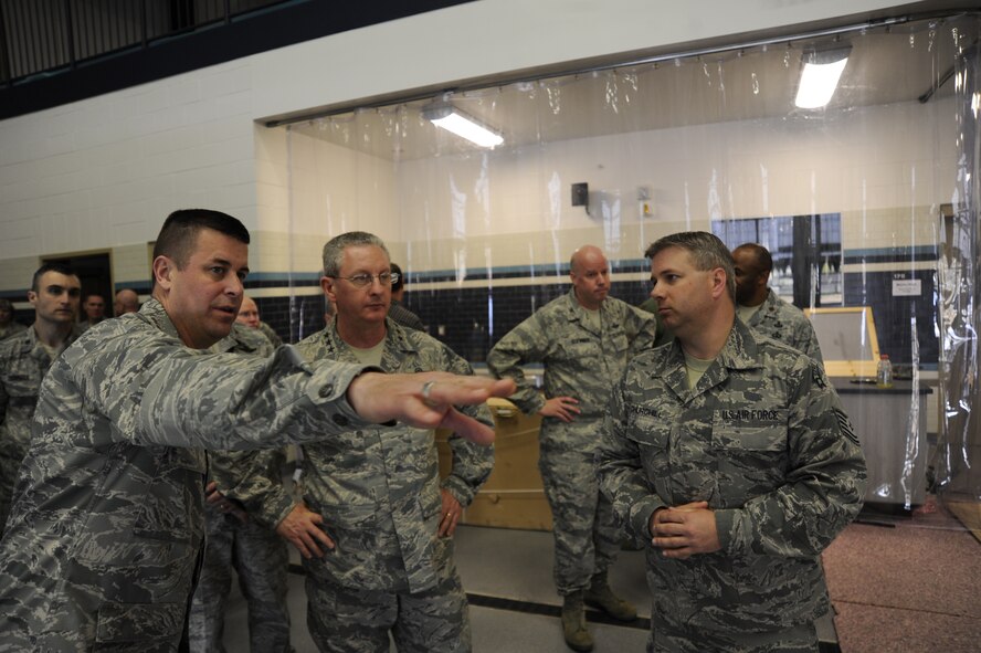 Col. Michael Hill, 92nd Mission Support Group commander, shows Lt. Gen. Mark Ramsay, 18th Air Force commander, around the aquatic center in the new fitness center at Fairchild Air Force Base, Wash., April 25, 2012. The aquatic center has state of the art equipment designed to train Airmen undergoing the Survival, Evasion, Resistance and Escape water survival course. (U.S. Air Force photo by Airman 1st Class Ryan Zeski/Released)