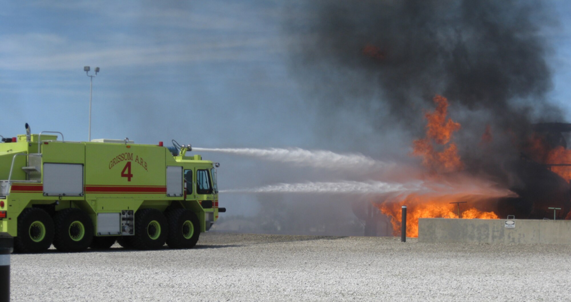 GRISSOM AIR RESERVE BASE, Ind., --  Under the watchful supervision of trained base firefighters, an honorary commander inside the cab of a fire truck aims the water cannon during an interactive visit to the base outdoor fire training facility.  (U.S. Air Force photo/Lt. Col. Gary Lockard)                           