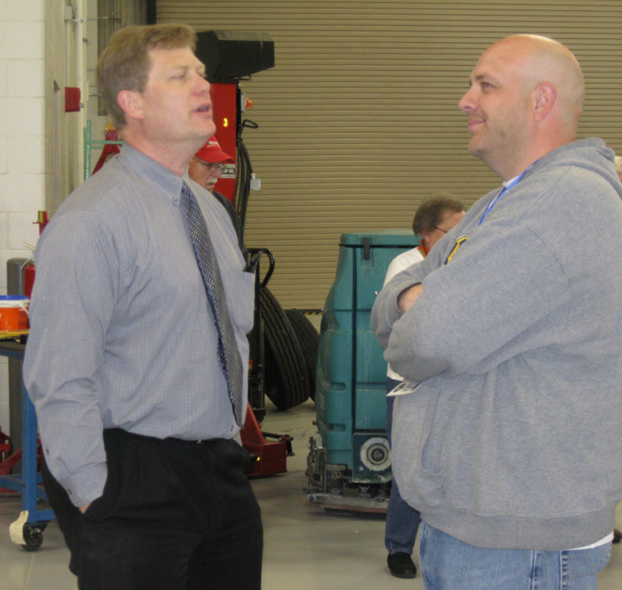 GRISSOM AIR RESERVE BASE, Ind., -- Mr. Mark Lammers (left), chief of the base contracting office, talks with Chris Theisen, honorary 434th Air Refueling Wing Command Chief, during a tour of the renovated transportation building and motor pool. (U.S. Air Force photo/Lt. Col. Gary Lockard)                               